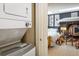 View of the charming bedroom highlighting a modern stacked washer/dryer just outside the doorway at 801 Confidence Dr # 2, Longmont, CO 80504