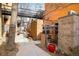 Backyard courtyard featuring modern architecture, landscaping, outdoor dining, and a unique walkway at 801 Confidence Dr # 2, Longmont, CO 80504