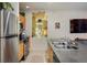 Kitchen with stainless steel appliances, an island sink, and a view into the living area at 801 Confidence Dr # 2, Longmont, CO 80504