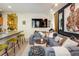 Open living room with modern decor, a large sectional sofa, and a stylish breakfast bar at 801 Confidence Dr # 2, Longmont, CO 80504