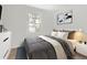 Calm bedroom with soft lighting, comfortable queen bed, and modern decor at 2621 S Federal Blvd, Denver, CO 80219