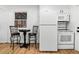Kitchenette includes a table and seating beside the refrigerator and stove at 2621 S Federal Blvd, Denver, CO 80219