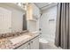 Full bathroom featuring granite countertop, subway tile surround and tub with shower at 49950 Oak Park Dr, Bennett, CO 80102