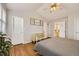 Bedroom features vaulted ceiling, wood floor, and multiple access doors at 49950 Oak Park Dr, Bennett, CO 80102