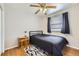Bedroom featuring ceiling fan, wood floor, updated windows and small closet at 49950 Oak Park Dr, Bennett, CO 80102