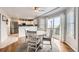Bright dining area with backyard access featuring a round table, white chairs and stainless steel appliances at 49950 Oak Park Dr, Bennett, CO 80102