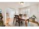 Inviting dining area with hardwood floors, a rustic table set and decor plus backyard access at 49950 Oak Park Dr, Bennett, CO 80102