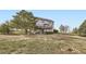 Two-story home with a walkout basement and a backyard deck offering privacy at 49950 Oak Park Dr, Bennett, CO 80102