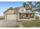 Charming two-story home with brick accents, front porch, and attached two-car garage with basketball hoop at 49950 Oak Park Dr, Bennett, CO 80102