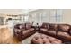 Bright living room boasts hardwood floors, large windows, and comfortable seating creating a welcoming atmosphere at 49950 Oak Park Dr, Bennett, CO 80102