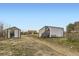 View of multiple outbuildings on the property, offering versatile storage options at 49950 Oak Park Dr, Bennett, CO 80102