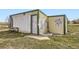 Exterior of a small, weathered shed with graffiti art on the side at 49950 Oak Park Dr, Bennett, CO 80102