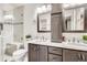 Modern bathroom featuring double vanity, updated fixtures, and a glass-enclosed shower at 6367 Xavier St, Arvada, CO 80003