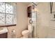 Bathroom featuring a vanity with a dark wood cabinet, a glass shower and a window with coverings at 6367 Xavier St, Arvada, CO 80003