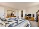 Spacious bedroom with a queen bed, a dresser with mirror and TV on a wooden cabinet at 6367 Xavier St, Arvada, CO 80003