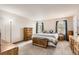 Bright bedroom featuring a plush bed, matching nightstands, and wooden dressers at 6367 Xavier St, Arvada, CO 80003