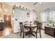 Cozy dining area with a round table, four chairs, and natural light from sheer curtains at 6367 Xavier St, Arvada, CO 80003
