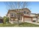 Inviting exterior with a well-manicured lawn, two-car garage and covered porch at 6367 Xavier St, Arvada, CO 80003