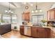 Bright kitchen featuring wooden cabinets, granite countertops, stainless steel dishwasher, and a large window at 6367 Xavier St, Arvada, CO 80003