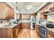 Well-equipped kitchen featuring stainless steel appliances, wood cabinets, and granite countertops at 6367 Xavier St, Arvada, CO 80003
