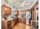 Well-lit kitchen featuring stainless steel appliances, granite countertops, and wooden cabinets at 6367 Xavier St, Arvada, CO 80003