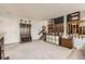 Cozy living room area with custom shelving and stairs, as well as an entryway nook with coat hooks at 6367 Xavier St, Arvada, CO 80003