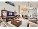 Open-concept living area featuring a large TV, comfortable seating and a dining table at 6367 Xavier St, Arvada, CO 80003