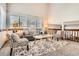 Bright living room with high ceilings, large windows, comfortable seating, and stylish decor at 6367 Xavier St, Arvada, CO 80003