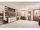 Spacious living room featuring carpet, a stone fireplace, natural light and a display case at 6367 Xavier St, Arvada, CO 80003