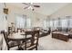 Open-concept living area featuring comfortable sofas, a dining table and natural lighting at 6367 Xavier St, Arvada, CO 80003