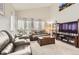 Comfortable living room with vaulted ceilings, neutral carpet, and modern furnishings at 6367 Xavier St, Arvada, CO 80003