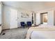 Comfortable main bedroom featuring neutral tones, soft carpet, and two cozy accent chairs at 6367 Xavier St, Arvada, CO 80003