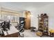 Home office setup with a desk, office chair, and storage cabinets with natural light at 6367 Xavier St, Arvada, CO 80003