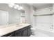 Well-lit bathroom features a shower-tub combo, and black vanity cabinet at 2366 Central Park Blvd, Denver, CO 80238