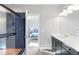 Modern bathroom featuring a tiled shower, vanity, and view into the bedroom at 2366 Central Park Blvd, Denver, CO 80238