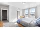 Bright bedroom with natural light, plush carpet, neutral paint, and two windows with scenic neighborhood views at 2366 Central Park Blvd, Denver, CO 80238
