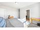 Bright bedroom with neutral tones, wood furniture, and an en-suite bathroom at 2366 Central Park Blvd, Denver, CO 80238