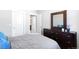 Comfortable bedroom featuring a dresser, closet, and ensuite bathroom at 2366 Central Park Blvd, Denver, CO 80238