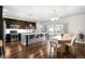 Spacious kitchen and dining area featuring an island, wood floors, and plenty of counter seating at 2366 Central Park Blvd, Denver, CO 80238
