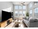 Bright living room boasts soaring ceilings, lots of natural light, and sleek hardwood floors at 2366 Central Park Blvd, Denver, CO 80238