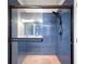 Modern bathroom with a blue tiled shower and a glass door at 2366 Central Park Blvd, Denver, CO 80238