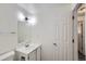 Bathroom featuring a modern sink and mirror adjacent to a white door at 62 Newark St # D, Aurora, CO 80012