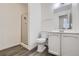 Bright bathroom with walk-in shower, wood-look vinyl flooring and white vanity at 62 Newark St # D, Aurora, CO 80012