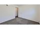 Bright bedroom with a neutral colored wall to wall carpet and a white door at 62 Newark St # D, Aurora, CO 80012