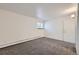 Bright bedroom with a window and wall to wall carpet and a white door at 62 Newark St # D, Aurora, CO 80012