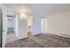 Bedroom with a walk in closet, neutral carpet, and white walls at 62 Newark St # D, Aurora, CO 80012