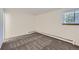 Bedroom with a window and wall to wall carpet and white walls at 62 Newark St # D, Aurora, CO 80012