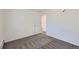 Bright bedroom with a neutral colored wall to wall carpet and a white door at 62 Newark St # D, Aurora, CO 80012
