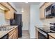 Kitchen showcases light cabinets, stainless steel sink, and modern black appliances at 62 Newark St # D, Aurora, CO 80012