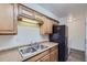 Kitchen features light wood cabinets, stainless steel sink, and black appliances at 62 Newark St # D, Aurora, CO 80012